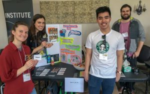 Graduate students present an educational display on fruit flies